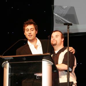 Blair Williamson helping Brad Falchuk accept his Media Access Award for writing NIP/TUCK's TOMMY BOLTON starring Blair as Tommy.