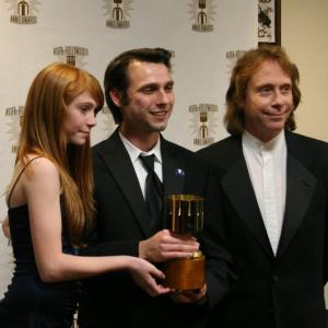 Presenters Liliana Mumy l and Bill Mumy r with Michal Makarewicz winner for feature character animation