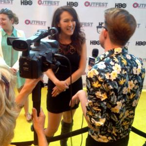 Simone Bailly getting interviewed at the LA Premiere of LIFE PARTNERS Outfest LA Opening Night Gala