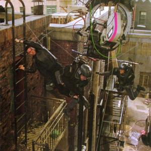 Minority Report  Chief John Anderton Tom Cruise leaps from the fire escape and grabs hold of flying PreCrime Cops Petra Sprecher on far right Cinefex