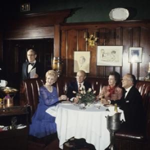 Maude Chasen at Chasens Restaurant photographer Wallace Seawell seated at the far right