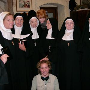 Jan Dunn sitting with Cast of Nuns for The Calling