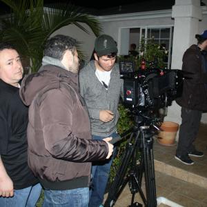 Sam Osman far right getting Scene Instructions from Director Jared Cohn on the Set of Buddy Hutchins On the far left Executive Producer Gabriel Campisi