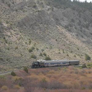 2008. San Luis & Rio Grande #18 and train is dwarfed by Cucharas Range foothills east of Ft. Garland.