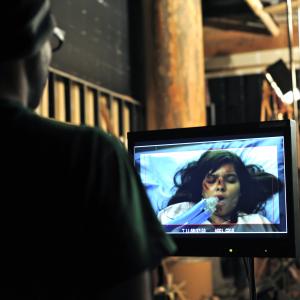 Director David Langlois sits behind the monitor during the shooting of the Fathoms 2022 music video 2012