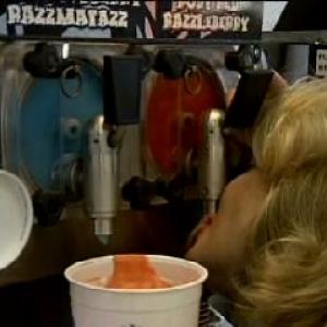 Suzanne Sole sucking a slurpee from the machine as White Trash Mom in What News? for TBS