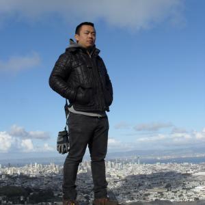 Nu Zhang standing on top of the world; San Francisco CA.