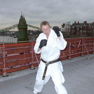 Adrian Rayment prepares to attack on a roof-top near Hammersmith bridge, London, UK.