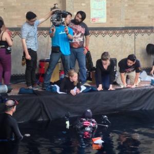Amanda Tasse (center right) directs stunt double Andrea Kemp (center) and actor Vanessa Patel (center for a pool VFX action scene in MIRA.