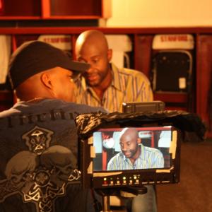 Producer Andre Gordon with host Jerry Rice on the set of 