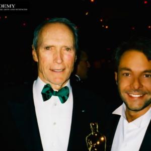 DAVID GIAMMARCO and CLINT EASTWOOD pictured holding the Best Picture and Best Director Oscars® at the Academy Awards Governor's Ball.