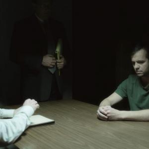 Todd Jenkins as Bruce Chesser getting interrogated