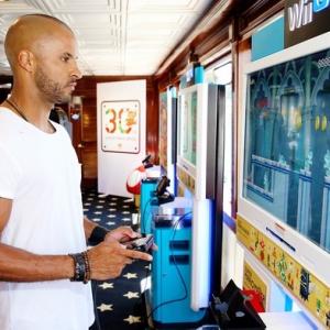 Ricky Whittle playing on the new Nintendo WII at TV guide yacht San diego comic con 2015