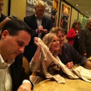 Mark Joseph, Jenn Gotzon and John Schneider signing Doonby tshirts at NRB