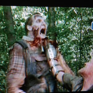 Frame capture of getting killed by Michael Rooker as Merle on the Walking Dead Season 3