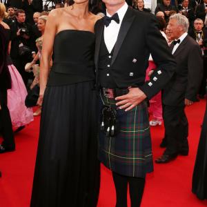 Former Formula 1 driver David Coulthard R and Karen Minier attend Weekend Of A Champion Premiere during the 66th Annual Cannes Film Festival at Palais des Festivals on May 22 2013 in Cannes France