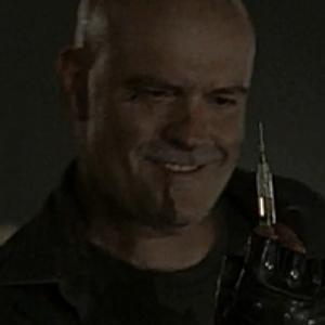 James Collins as Cueball from Falling Skies TV Series Cueball just about to inject Billy with a syringe to help ease the pain of his bullet riddled leg