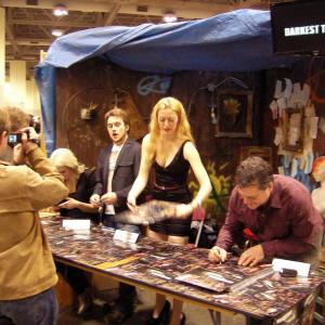 Holly Sarchfield signing autographs and giving photo ops for fans with the cast of Darkest Times at Toronto ComiCON 2013.