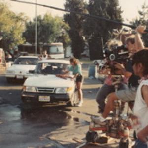 Jan Mrlyn Reesman directing on set of Bikini Car Wash. Robin Jameson washing car.