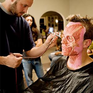 Special effects makeup artist Patrick Magee works his magic on actor Travis Wood