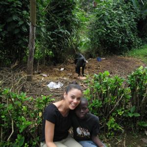 Tessa Munro with a Haitian boy Samuel and a cute pig behind them in the mountains of Haiti January 2012 Humanitarian work and Haiti are important to her