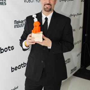 Director Daniel Azarian holds a 2012 Botsker Award for Teenage Popstar Girl at the 2012 Robot Film Festival NYC
