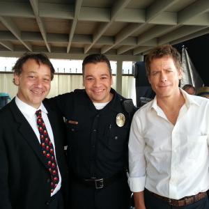 On location of RAKE Playing Officer Luke Torres with Greg Kinnear and director Sam Raimi