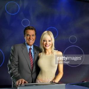 Co Hosts of the Game Show Network Show Lingo Chuck Woolery and Stacey Hayes pose on set