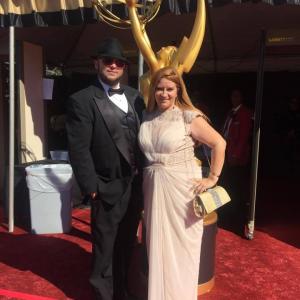 Writer Chris Molina and Producer Peggy Lane arrive at the 2015 Emmys.