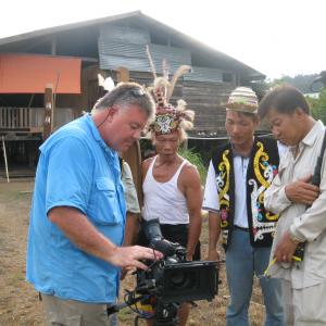 replaying footage to the villagers in Sarawak jungle Malaysia