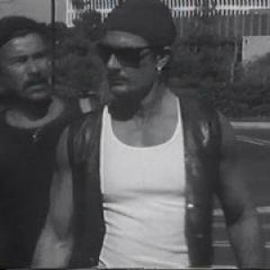 Carlo (dba Charlee Thomas) as Azar and Richard Dino as DEA Agent Coppola square off in the 'indie' film 'Paraiso O Riesgo (Paradise Or Risk)' from 1996.
