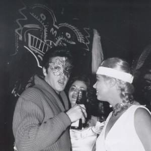 JEANNE CARMEN  ELVIS PRESLEY at SY DEVORES Halloween party October 31st 1957 Beverly Hills California Note This is the only known photo of Elvis with beer in hand Note Elvis drinks CARTA BLANCA Cerveza fit for a King