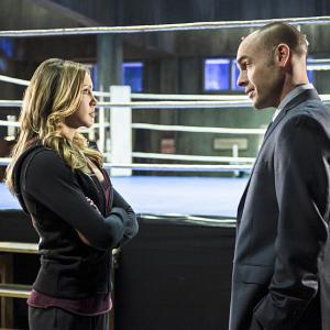 Still of Paul Blackthorne and Katie Cassidy in Strele 2012