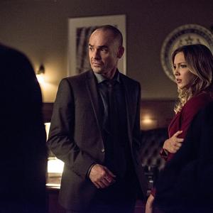Still of Paul Blackthorne and Katie Cassidy in Strele 2012