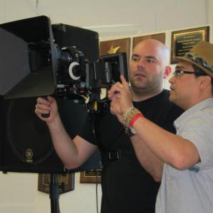 Kevin frames the shot with DP, William Somerby on the set of back2one.