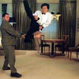 Jimmy Tong (JACKIE CHAN, right) almost gets caught with his pants down in a fight with one of Banning's henchmen (BRADLEY JAMES ALLEN, left)