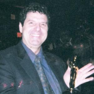 Rich Rossi holds an Oscar at an Academy Awards after party