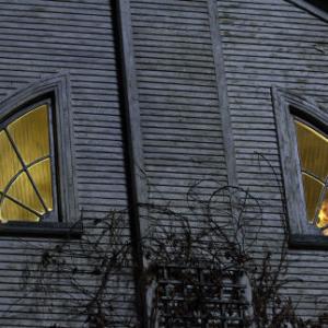 Chelsea Lutz CHLOE MORETZ right and Jodi ISABEL CONNER look through the eyes of the house in THE AMITYVILLE HORROR