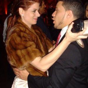 Ramses Jimenez and Debra Messing at the premier of Nothing Like the Holidays