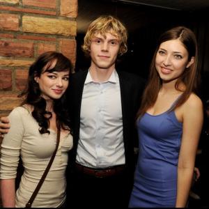 Actress Shelby Young poses with costar Evan Peters and actress Ashley Rickards at the premiere of American Horror Story