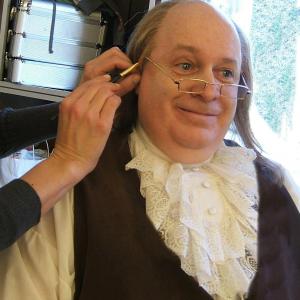Brian Patrick Mulligan receives one last touch up from top make up artist Brenna Bash for his role as Benjamin Franklin