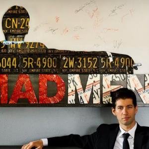 Foster poses with a piece of his art signed by the cast and creator of Mad Men.