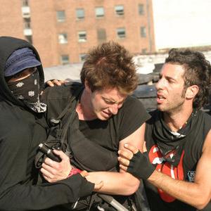 Tina (ROSARIO DAWSON) left and Cody (BRETT BERG) right, help Jake (NATHAN CROOKER) after he is beat down in THIS REVOLUTION.