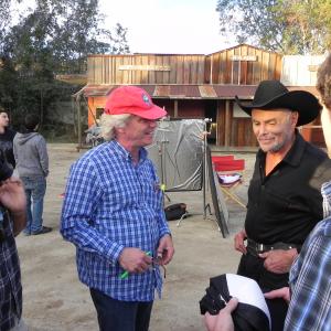 Michael Donahue directs John Saxon on The Extra set at Audie Murphy Ranch Actor David Imani L and production designer Jeremy Lyons R discuss western sequence