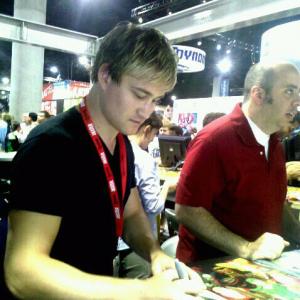 Brendan signing photos for LEGEND OF NEIL at Comic Con 2010