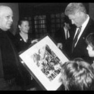 Edward Bass presents then sitting president Bill Clinton a photograph from his collection