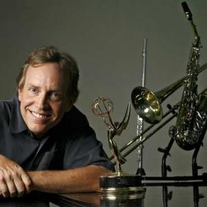 Larry Newman with his Emmy and collection of musical instruments.
