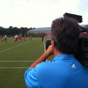 Troy shooting an NFL football practice.