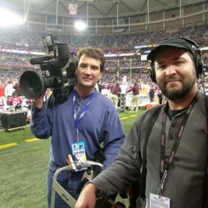 Inertia Films' cameraman A. Troy Thomas (L) and soundman Darryl Mitchell (R) shoot for NFL Network at a Carolina Panthers v. Atlanta Falcons game in Atlanta's Georgia Dome.
