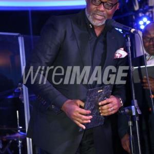 Richard MofeDamijo receiving an award for bet international actor at the Femdouble gala in BelAir